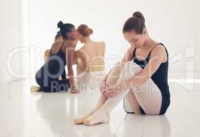Taste your words before you spit them out. a ballet dancer sitting away from the crowd looking nervous and stressed.