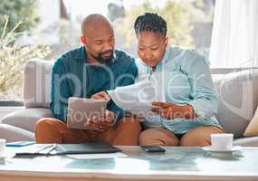 Make sure youre thorough. a mature couple looking through their bills while using a digital tablet.