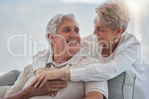 The love is still there for all to see. an affectionate senior couple relaxing in their living room at home.