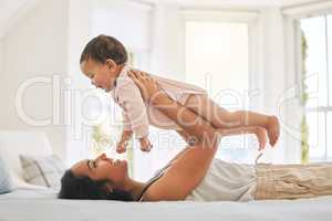 Mommys precious baby. an attractive young woman and her newborn baby at home.