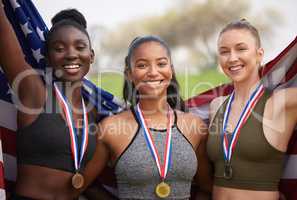 Representing their country. Cropped portrait of three attractive young female athletes celebrating their countries victory.