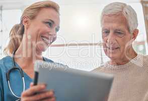 Sign up is completely free. a nurse using a digital tablet with her elderly patient.