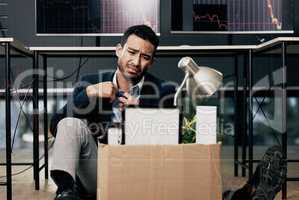 Giving up is the only sure way to fail. a young businessman looking depressed after being retrenched from work in a office.