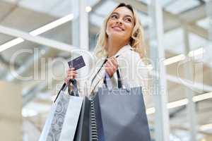 Youre coming home with me. a young woman holding the bank card used to make payments while shopping.