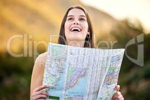 I love the beautiful city. a young woman holding a map while out exploring.