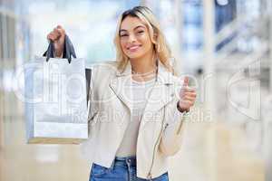Never doubt your intuition. a young woman giving the thumbs up while shopping.