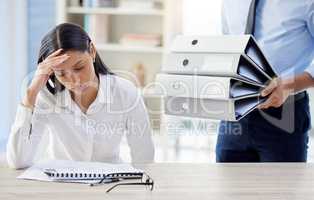 Is this really my life. a young businesswoman looking overwhelmed while receiving more work.