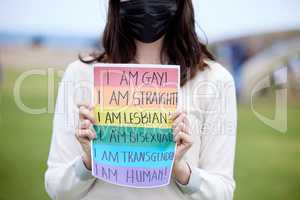 It doesnt make me less of a human. a woman holding up a sign at an lgbtq rally.