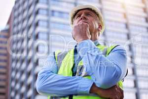 Whats the best way forward here. Low angle shot of a handsome mature male construction worker looking thoughtful while standing outside.