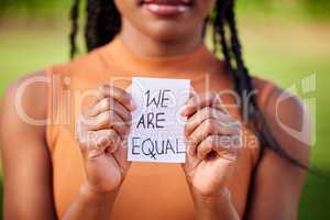 Democracy is about the dialogue. a unrecognizable woman holding a sign in protest outside.