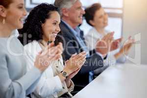 Clap while you wait for your time to shine. a group of businesspeople clapping hands while in a meeting at work.