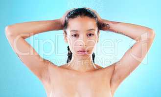 A shower is just what you need to ease the stress of the day. a young woman enjoying a shower against a blue background.