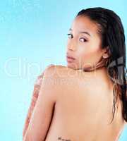 Did I miss a spot. a young woman enjoying a shower against a blue background.