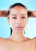 Taking a shower calms me, recharges me and just makes me feel good. a young woman enjoying a shower against a blue background.