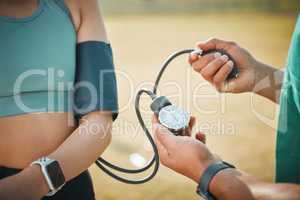 Athletes need to undergo routine health checks. Closeup shot of an unrecognisable sports paramedic checking an athletes blood pressure.