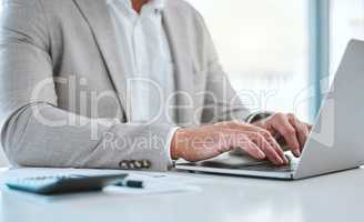 Money is better than poverty, if only for financial reasons. a unrecognizable man using a laptop in a office.