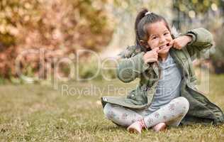 Look, I still have all my teeth. an adorable little girl sitting outside.