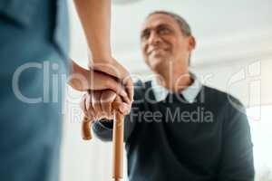 We get up every time. a nurse helping an older man stand up and use his walking stick.