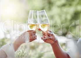 Theres always something to celebrate. two unrecognizable people toasting with wine glasses at home.