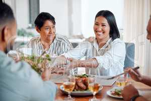 Kindness comes in the simplest ways. a family having lunch together at home.