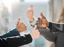 Anything you give us we can handle. a group of business people giving the thumbs up.