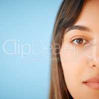 Simply lovely. Closeup portrait of a beautiful young woman against a blue background.