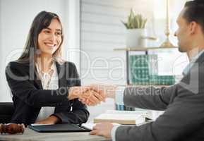 Lets see if we can sort out this trouble. a female lawyer shaking hands with her client.