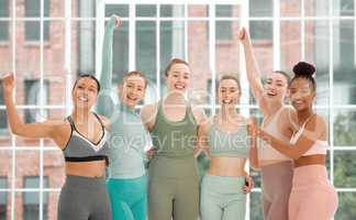 Claim your power. a group women standing together in their workout clothes.