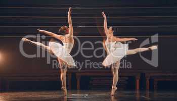 Dancers come and go in the twinkling of an eye. a two of ballet dancers practicing a routine on a stage.