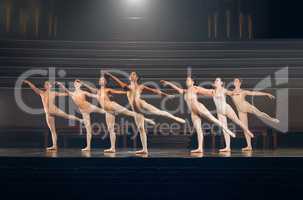 I only try to dance better than myself. a group of ballet dancers practicing a routine on a stage.