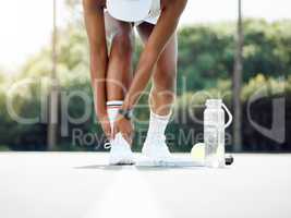 You have to be careful when running across the court. Closeup shot of a sporty young woman experiencing ankle pain while playing tennis outdoors.