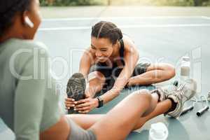 They always start with the warmup. two attractive young female athletes warming up outside before beginning their workout.