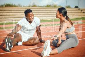 For the love of fitness. Full length shot of a young athletic couple warming up before starting their outdoor exercise routine.