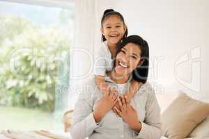 Precious moments while getting ready for the day. Portrait of a young mother and daughter bonding together at home.