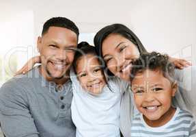 A fathers pride, a husbands treasure. Portrait of a beautiful young family talking and bonding at home together.