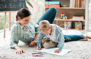 Families are the compass that guides us. a mother and son playing in the lounge at home.