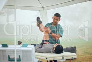 Lets check your range of motion. a handsome young male physiotherapist working on a female patient outside.