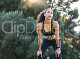 A lack of focus leads to a lack of progress. a sporty young woman catching her breath while exercising outdoors.