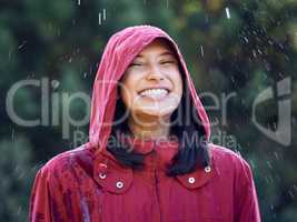 I feel a calmness washing over me. a young woman smiling while standing in the rain.