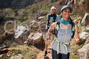 Best friends keep each other fit. two young women running along a trail on the mountain.