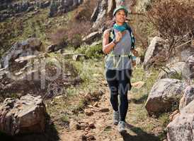 I will prove to myself that I can do this. a young woman running along a trail on the mountain.