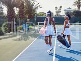 Have the ability to handle the win with the dignity. two attractive women standing together while playing tennis outside.