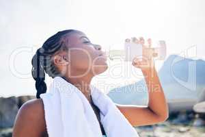 Now Im thirsty. a woman drinking water while out for a workout.