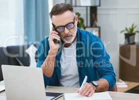 Repeat that for me slowly. a mature businessman working from home while making a phone call.