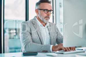 Dont let other people write your script. a mature man using a computer at work in a office.