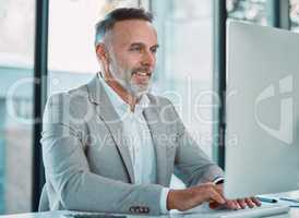 You define your own life. a mature man using a computer at work in a office.