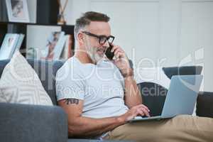 I think we should meet in person. a mature businessman using his laptop to work from home while making a phone call.