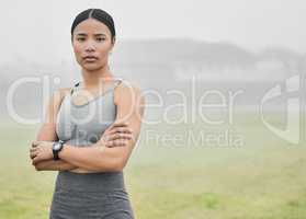 Build fitness, build confidence. Cropped portrait of an attractive young female athlete standing with her arms folded while exercising outside.