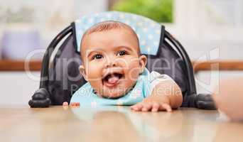 You had me at are you hungry. an adorable baby boy looking happy while eating a meal.