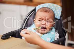 Im hungry but not for this. a baby crying while being fed by his mother.